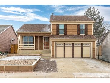 Traditional two-story home featuring a three-car garage and well-maintained front yard at 2888 S Fundy St, Aurora, CO 80013