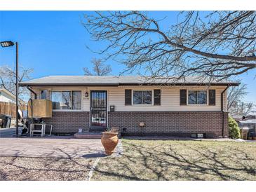 Charming single-story home with a brick foundation and well-maintained lawn at 8244 Clemson Ln, Westminster, CO 80031