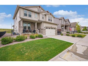 Beautiful two-story home with stone accents, a manicured lawn, and a two-car garage, offering great curb appeal at 8078 S Yantley Ct, Aurora, CO 80016