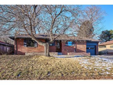 Brick ranch house with a mature tree and well-maintained landscaping at 725 S Harrison St, Denver, CO 80209