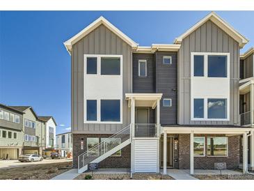 Charming two-story townhome featuring modern architecture and inviting entry with stairway to a second floor unit at 641 Skyhook St, Erie, CO 80516