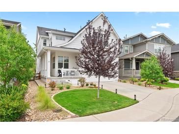 Charming two-story home featuring a beautifully landscaped yard, front porch, and inviting curb appeal at 2027 Vallejo Loop, Broomfield, CO 80023