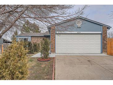 Cozy single-Gathering home with a white garage door and manicured front yard at 4234 S Bahama St, Aurora, CO 80013