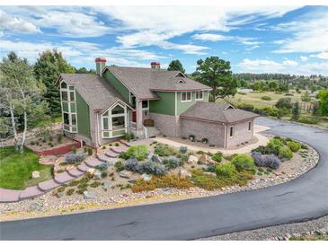 Luxury home with circular driveway and landscaped grounds, offering mountain views at 4812 Moonshine Ridge Trl, Parker, CO 80134