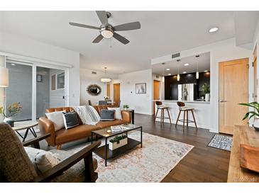 Spacious living area showcasing a modern open floor plan with kitchen, dining, and sitting areas at 1585 Hecla Way # 201, Louisville, CO 80027