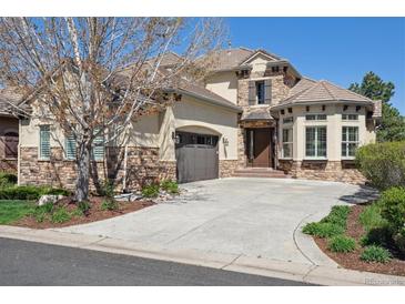 Charming two-story home featuring stone accents, a curved driveway, and mature landscaping at 35 Brookhaven Pl, Littleton, CO 80123