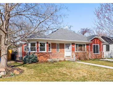 Charming red brick single-story home with manicured lawn and walkway leading to the front door at 1273 S Jackson St, Denver, CO 80210