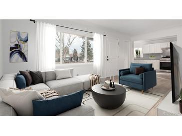 Bright living room featuring a large window, modern sectional, and stylish decor at 1225 S Xavier St, Denver, CO 80219