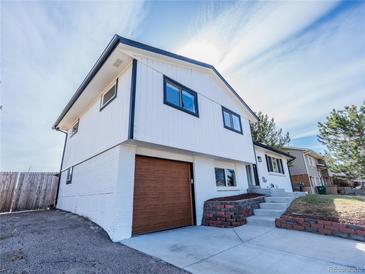 Two-story home boasting a modern design and a well-manicured lawn at 4328 S Carr Ct, Littleton, CO 80123