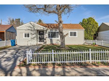 Charming single-story home featuring a well-maintained front yard with a classic white picket fence at 1364 Lansing St, Aurora, CO 80010