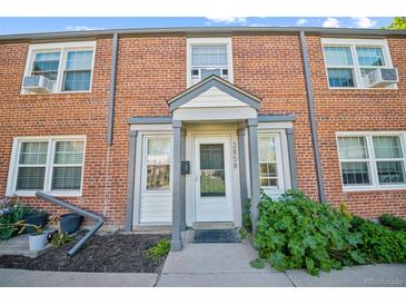 Charming brick townhouse featuring front door with sidelights and a covered entryway, perfect for curb appeal at 2858 Jasmine St, Denver, CO 80207