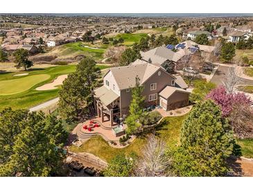 Stunning home boasts an inviting outdoor space with a cozy fire pit and meticulously landscaped yard, perfect for entertaining at 6462 S Versailles Ct, Aurora, CO 80016