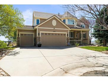 Beautiful two-story home featuring a three-car garage and stone accents, set in a well-manicured lawn at 6462 S Versailles Ct, Aurora, CO 80016