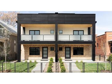 Modern two-story duplex with brick facade, black accents, and private balconies at 425 S Pearl St, Denver, CO 80209