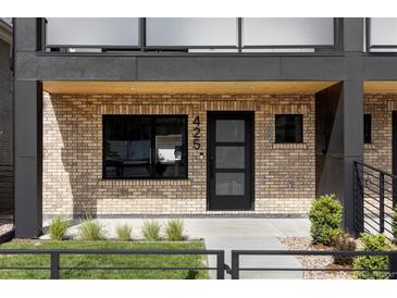 Modern brick home with black framed windows and front door that has decorative glass panels at 425 S Pearl St, Denver, CO 80209