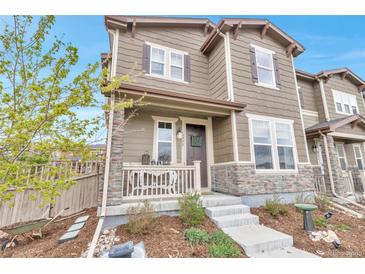 Charming two-story home with stone accents, covered porch, and well-maintained landscaping at 3778 Happyheart Way, Castle Rock, CO 80109