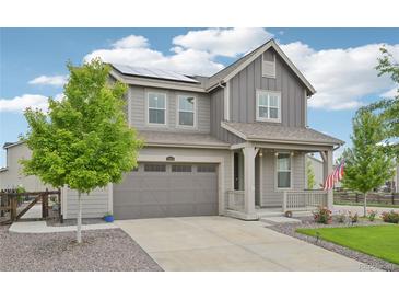 Charming two-story home with a landscaped front yard, solar panels, and an attached two car garage at 12854 Clearview St, Firestone, CO 80504