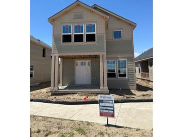 New two-story home boasts a welcoming front porch and modern design elements at 54 Waterford St, Erie, CO 80516
