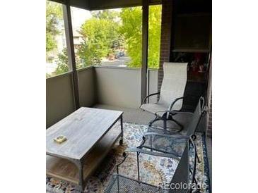 Relaxing screened-in patio with seating area and mountain views at 2227 Canyon Blvd # 312A, Boulder, CO 80302