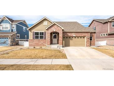 Charming brick home featuring a two-car garage and well-maintained front yard at 2317 Winding Dr, Longmont, CO 80504