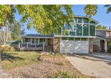 Inviting two-story home with a front porch and a two-car garage at 1101 E 7Th Avenue Cir, Broomfield, CO 80020