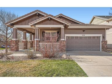 Charming single-Gathering home with a covered front porch and attached garage with concrete driveway at 3391 Prairie Vista Dr, Castle Rock, CO 80109