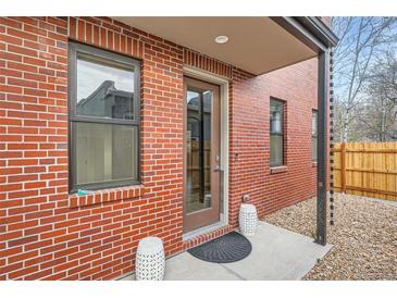 Charming brick home featuring a covered front entrance and a small, decorative front patio at 3643 Zuni St, Denver, CO 80211