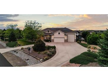 Stunning home with three-car garage, mature trees, solar panels and beautiful landscaping at 8211 E 128Th Pl, Thornton, CO 80602