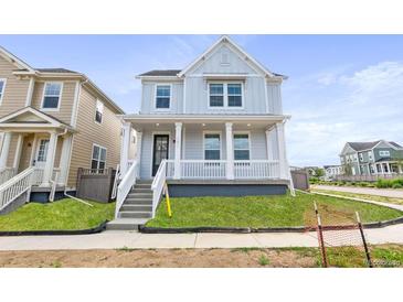 Charming two-story home with a welcoming front porch and well-manicured lawn at 251 Washington St, Erie, CO 80516