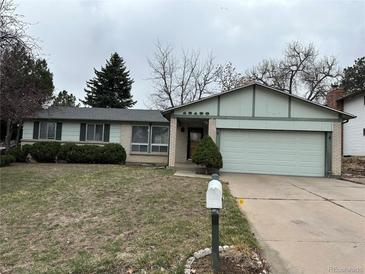 Charming single-Gathering home featuring an attached two-car garage and low maintenance landscaping at 16180 E Flora Pl, Aurora, CO 80013