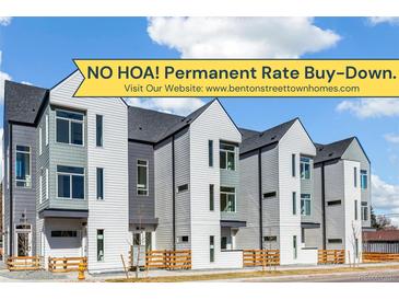 Modern townhomes featuring unique siding and large windows, offering stylish urban living with no HOA and rate buy-down at 5367 W 14Th Ave, Lakewood, CO 80214