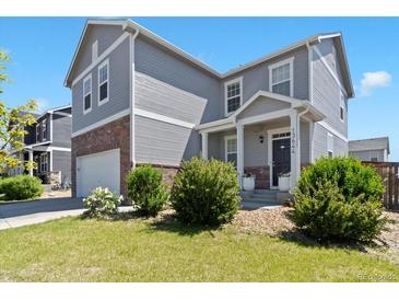 Charming two-story home with a well-manicured lawn and a welcoming front porch at 13644 Ulster St, Thornton, CO 80602