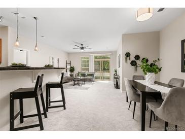 Bright dining area with a modern table and four gray chairs at 13456 Via Varra # 118, Broomfield, CO 80020