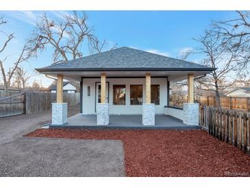 Newly renovated bungalow with modern facade, covered porch, and landscaped yard at 1765 Ingalls St, Lakewood, CO 80214