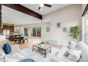 Bright open-concept living space with modern furnishings and light hardwood floors at 1848 W 68Th Ave, Denver, CO 80221
