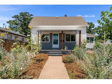 Charming bungalow with landscaped front yard and walkway at 1111 E Dartmouth Ave, Englewood, CO 80113