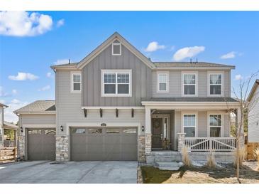 Charming two-story home with a porch, three-car garage, and well-manicured front lawn at 840 Avena Dr, Elizabeth, CO 80107
