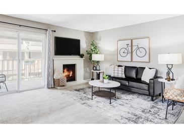 Inviting living room featuring a fireplace, modern decor, and a sliding glass door leading to outdoor space at 5300 E Cherry Creek South Dr # 620, Denver, CO 80246