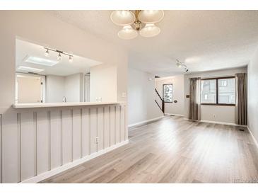 Bright, open living area with wood floors, large windows, and neutral decor provides a welcoming atmosphere at 10490 W Jewell Ave # D, Lakewood, CO 80232