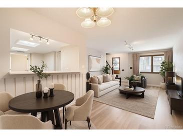 Bright living room with modern lighting, neutral tones, and open-concept design for easy entertaining at 10490 W Jewell Ave # D, Lakewood, CO 80232