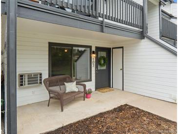 Inviting condo entrance with a charming wicker bench, perfect for enjoying the outdoors at 532 Oakwood Dr # D103, Castle Rock, CO 80104