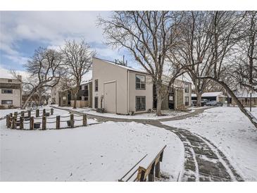 A charming multi-Gathering home featuring snow-covered grounds and mature bare trees in a peaceful setting at 3550 S Harlan St # 182, Denver, CO 80235