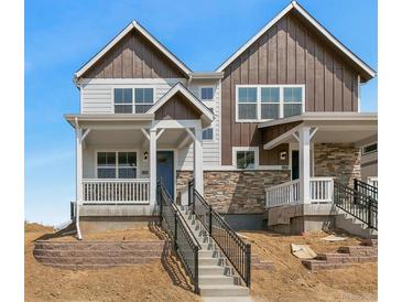 Charming two-story home with stone accents and a welcoming front porch and new landscaping at 22272 E 7Th Pl, Aurora, CO 80018