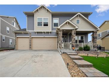 Charming two-story home with a three-car garage and stone-accented facade at 20888 E 51St Pl, Denver, CO 80249