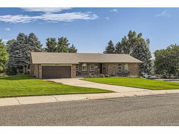 Brick ranch house with attached garage and landscaped lawn at 13627 W Alaska Dr, Lakewood, CO 80228