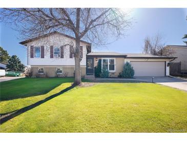 Charming two-story home with a well-maintained lawn and mature trees at 1922 S Ivory Way, Aurora, CO 80013