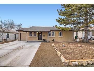 Charming single-story home featuring a covered entry, well-maintained lawn, and a detached garage at 1519 S Lowell Blvd, Denver, CO 80219