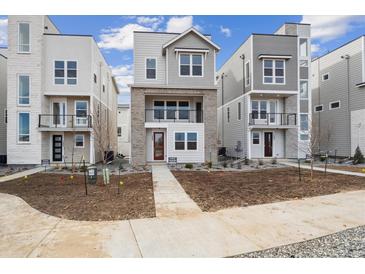 Newly constructed two-story home featuring modern architecture and a well-manicured front yard at 1263 Rhett Dr, Erie, CO 80026