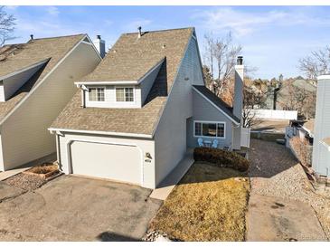 Charming townhome featuring a two-car garage and inviting front patio area at 10588 E Park Mtn, Littleton, CO 80127