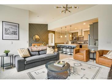 Bright, open-concept living area features stylish furniture and seamless flow to the modern kitchen at 6770 Zebra Grass Ln, Parker, CO 80138